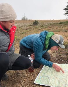 Two backpacker using a map