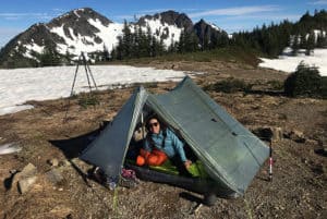 shows a backpacker with their backpacking essentials