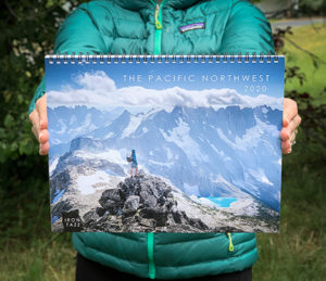 person displaying the cover of the calendar 
