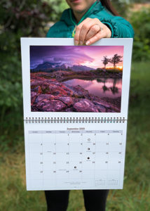 person holding calendar to show what it looks likes