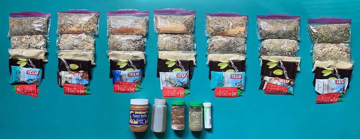 shows 7 days of backpacking food laid out on the ground