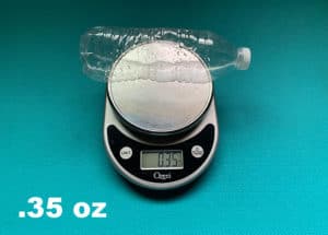 shows a disposable water bottle on a scale and its weight of .35 oz