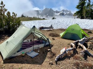 shows tent next to snow patch 