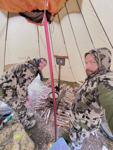Geared up in our hunting gear inside our hot tent.