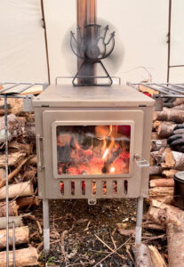 Heat powered fan sitting on top of a tent stove.