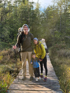 Family hiking together on a forest trail – enjoying the physical and mental benefits of hiking in nature
