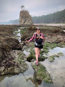 Family hiking with their baby along a coastal trail, exploring nature and bonding outdoors